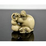 A Chinese carved ivory netsuke in the form of mice, signed to the base, circa 1900, 3½cm high.