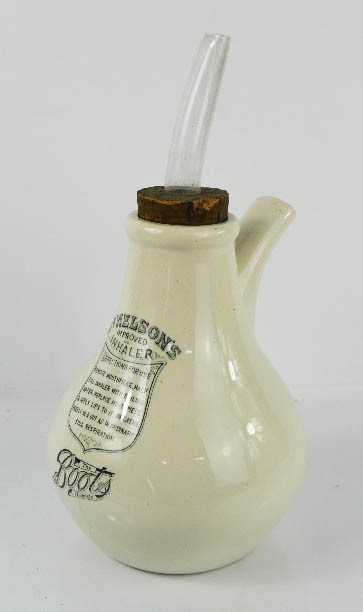 A vintage Boots ceramic inhaler, labelled and having the original cork stopper with glass