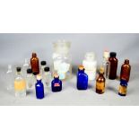 A group of glass chemists bottles, to include blue and brown examples.