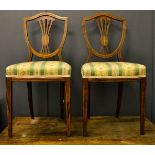 A pair of 19th century mahogany shield back bedroom chairs with upholstered seats.