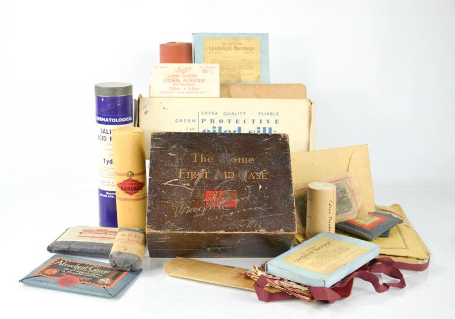 A group of vintage chemists accessories to include first aid box, umbilical and other bandages,