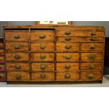 An antique pine Dispensing cabinet with two slide drawers, two slim drawers fitted with
