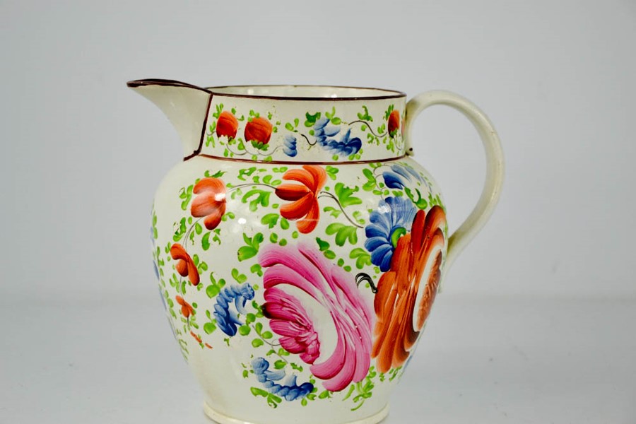 A Victorian Creamware Sunderland jugs; hand painted and depicting flowers, 20cm high. - Image 2 of 2