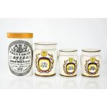 Three ceramic apothecary jars, each painted with labels, and a portmerion Cold Cream jar and