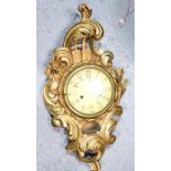 A giltwood wall clock with arabic dial, the case composed of scrollwork.