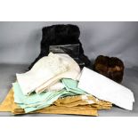 A quantity of vintage fabrics and two fur hats one Russian style Ushanka