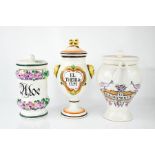 Three ceramic apothecary jars of differing form, each painted with contents labels.