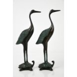 A pair of bronze cranes standing upon tortoises, 23cm high.