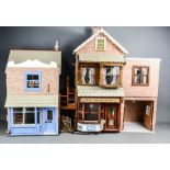 A large dolls house including Grocers shop, and Haberdashery shop complete with contents to