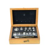 A set of vintage pharmaceutical weights, in the original box.