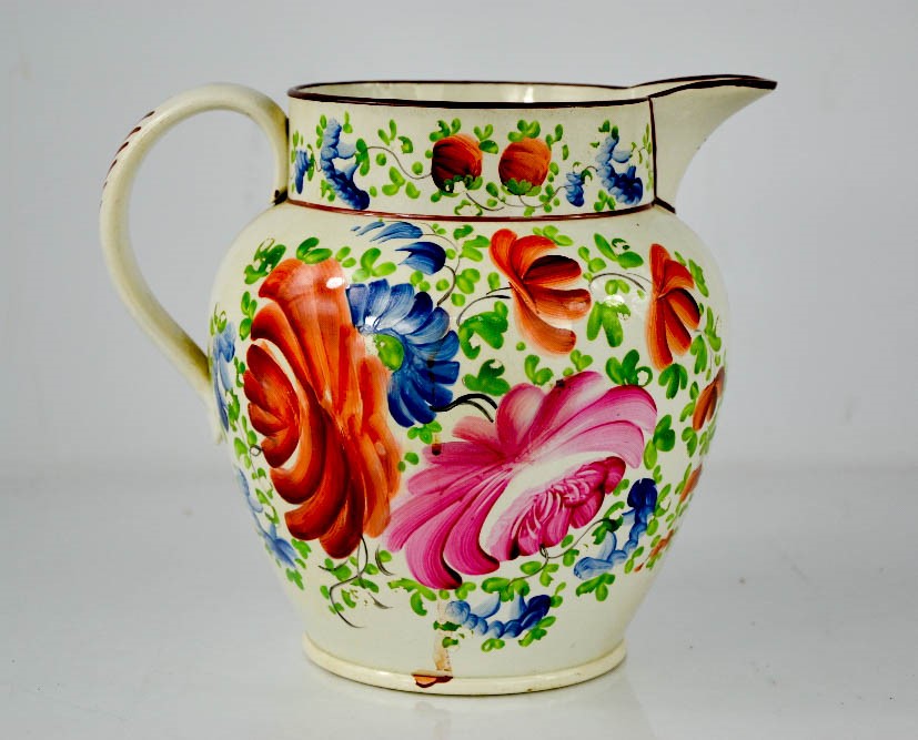 A Victorian Creamware Sunderland jugs; hand painted and depicting flowers, 20cm high.