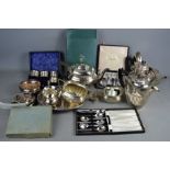 A quantity of silver plate to include spoons, napkin rings , teapots, and a boxed set of Harrods