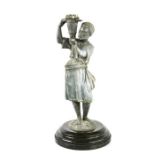A lead candle holder, in the form of an African man carrying a pale form candle socket, 32cm high.