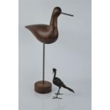 A naive treen bird together with a studio made metal example