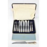 A silver handled butter knife and bread knife, and a boxed set.