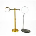 An antique magnifying lens on stand 21cm high, together with a mid-century example.