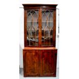 A 19th century mahogany cabinet, with the upper glazed section with arched astrigals, above two