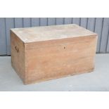 An antique pine chest with iron handles, 46 by 85 by 50cm.