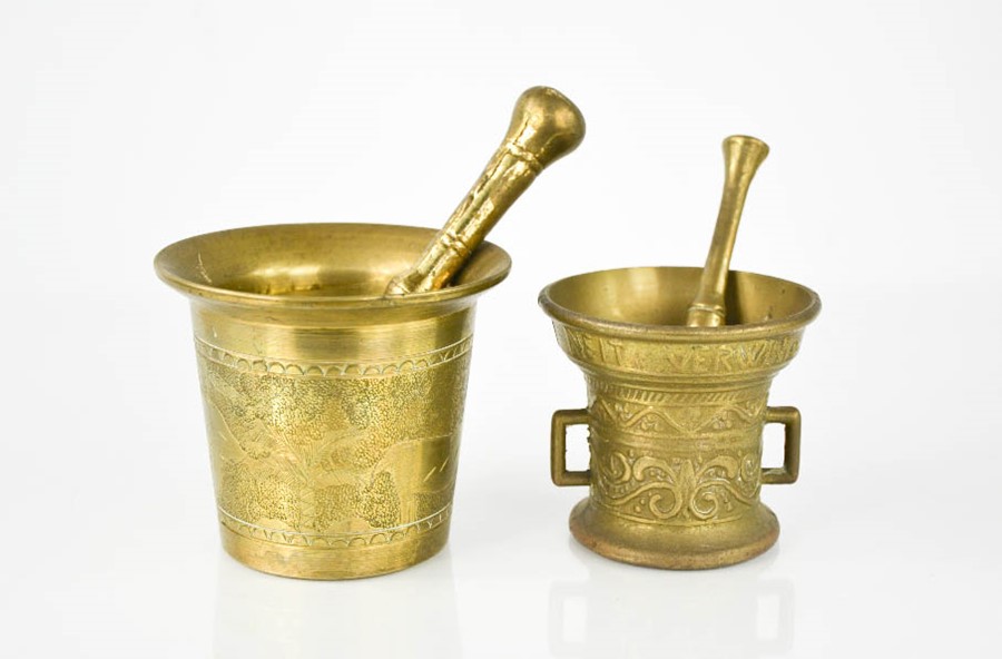 Two brass cast pestle & mortars, one engraved with animals, 8½ cm high.