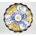 A 19th century Coalport porcelain plate, with cobalt blue ground, and panels of flowers in blue
