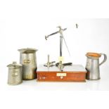 A vintage dispensing balance, by Evan Sons Lescher & Webb Ltd, together with three measuring jugs.