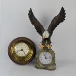 A mantle clock in the shape of a Golden Eagle together with a brass wall clock.