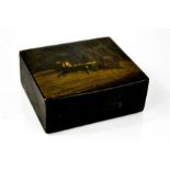 A Russian black lacquered box, with horses pulling a sleigh, 4 by 11 by 10cm.