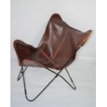 Two vintage style brown leather butterfly chairs one is boxed and unopened