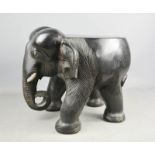 A wooden stool carved in the form of an elephant, 31cm high.