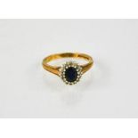 A 9ct gold, sapphire and diamond cluster ring, the oval sapphire surrounded by sixteen diamonds, 2.