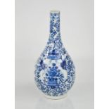 An early 19th century Chinese blue and white bottle vase, decorated with birds and flowers.