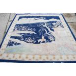 A large 20th century carpet depicting with a scene of the desert and figure on horseback. [Purchased