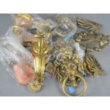 A quantity of brass lion head door knockers and brass fittings , handles etc