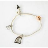 A Pandora bracelet with four charms.