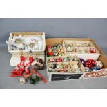 A group of vintage Christmas tree decorations, including baubles, lights, cake decorations and other