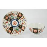 A First period Worcester tea bowl and saucer, polychrome porcelain tea cup and saucer, with floral