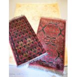 Two middle eastern prayer mats together with a rug