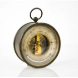 An antique thermometer, in gilt metal case, raised on two knop feet, 12cm diameter.