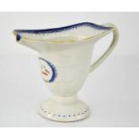 A 19th century sauce boat, bearing armorial crest with two birds, footed base, 11cm high.