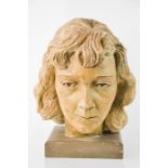A Studio made plasterwork head of a woman, raised on a plinth, 33cm high.