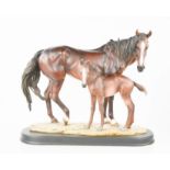 A resin study of horse and foal, stamped with Chinese symbol, 35cm high.
