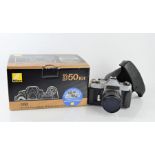 A Nikon D50 kit, boxed, and a Chinon example.