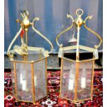 A pair of 19th century brass and glass panelled lanterns.