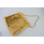 A vintage gold coloured evening bag by Droton for Harrods with a vintage silver coloured evening bag