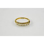 A gold and diamond seven stone half hoop eternity ring.