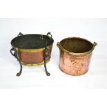 An Arts & Crafts copper and brass wrought iron log basket with ring handles, and a copper log bucket