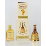 Three Bells celebration scotch whisky decanters together with a bottle of Bells extra special scotch