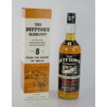 A bottle of Dufftown Glenlivet 8yr old deluxe highland malt scotch whisky