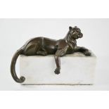 A bronze leopard, raised on a marble base, A/F