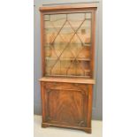 A 19th century glazed cabinet, the upper section with astrigal glazed door enclosing shelves,